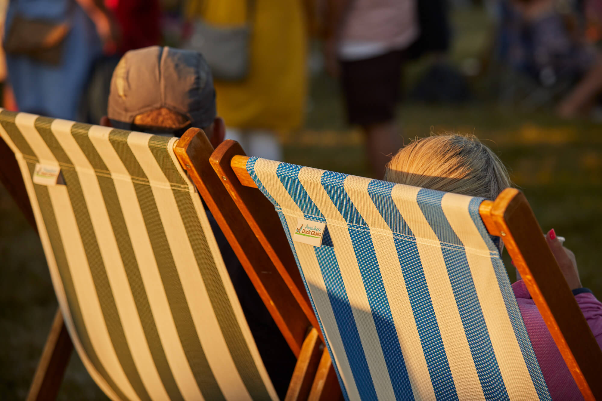 Two adults relaxing in deckchairs at an event at Borde Hill during the summer.